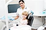 Smiling dentist with little girl after her check up