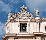 Maderno's facade with the sculptures and clock against the sky background. St. Peter's Basilica -  Vatican City.