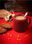 Cozy mug of coffee with cookies on a red table