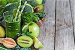 Green detox smoothie with raw vegetables and fruits. Copyspace background.