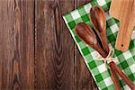 Kitchen cooking utensils over wooden table background. Top view with copy space