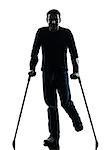 one man injured man with crutches in silhouette studio on white background