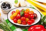 Italian food cooking ingredients. Vegetables, parmesan, basil on wooden table