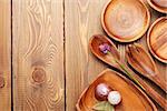 Wood kitchen utensils over wooden table background with copy space