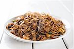 Stir fried char kuey teow over wooden background.  Fresh cooked with hot steams.