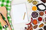 Various spices on white wooden background. Top view with notepad for copy space