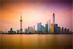 Shanghai, China cityscape viewed across the Huangpu River at dawn.