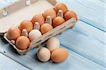 Cardboard egg box on blue wooden table