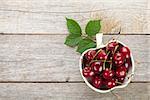 Ripe cherries on wooden table with copy space