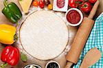 Pizza cooking ingredients. Dough, vegetables and spices. Top view with copy space