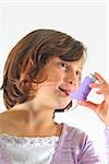 girl using inhaler, close up on white background