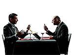 two businessmen dinning using smartphones in silhouettes on white background