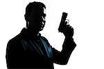 one  spy criminal policeman detective man holding gun portrait silhouette in studio isolated white background