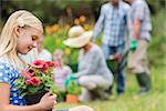 Young girl sitting with flower pot on a sunny day