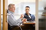 Businessmen having team meeting in conference room