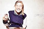 Studio shot of young woman eating chocolate marshmallows