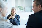 Over shoulder view of young businesswoman at interview in office