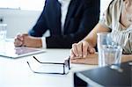 Close up of businessman and woman at conference table