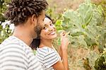 Couple pointing to names on cacti leaf, Ipanema beach, Rio De Janeiro, Brazil