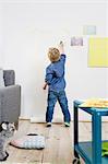 Boy drawing on wall