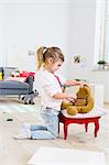 Girl playing doctor to soft toys