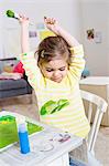 Girl playing with paint at home