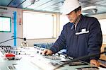 Worker using equipment at shipping port, GoSeong-gun, South Korea