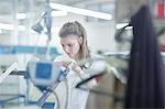 Woman at press machine in laundry