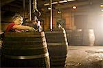 Mature man making whisky cask in cooperage