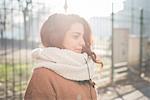 Young woman listening to headphones in park