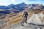 Mountain biker on dirt track, Valais, Switzerland