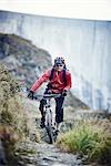 Mountain biker on dirt track, Valais, Switzerland