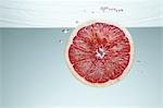 Slice of pink grapefruit underwater