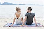 Young couple sitting on beach, Kradan, Thailand