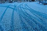 Low angle view of tire tracks on snowy highway, Reine, Lofoten, Norway