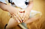 Close up of boy holding his knee with his hands