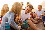 Group of friends camping on beach