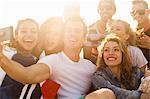 Group of friends taking selfie on beach