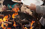 Group of friends having barbecue on beach