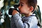 Boy taking photograph with camera