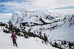 Young male skier moving along mountainside, Mount Baker, Washington, USA