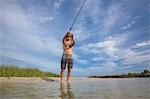 Low angle view of mature man fishing, Fort Walton, Florida, USA