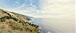 Panoramic view of sunlit coastline and sea, Big Sur, California, USA