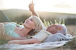 Mature couple lying on blanket looking up