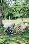 Father in garden with child in buggy