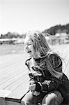 Laughing girl sitting on jetty