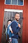 Father carrying his baby son in baby carrier