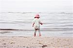 Baby girl standing on beach