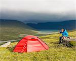 Mature hiker camping in mountains