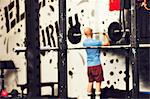 Exercising equipment in gym, man on background